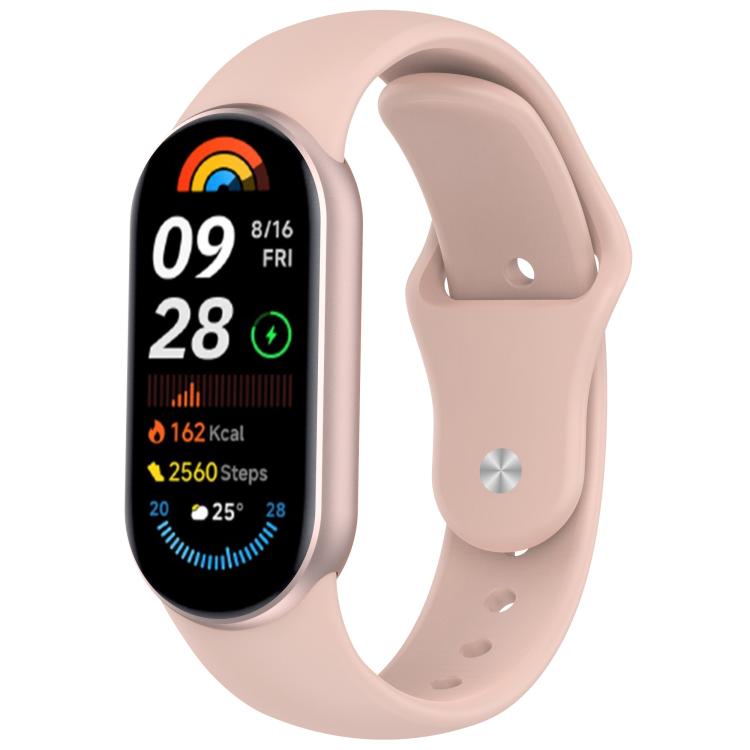 Pale pink silicone watch band with reverse buckle fitted to a fitness tracker