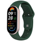 Dark green silicone watch band with reverse buckle fitted to a fitness tracker