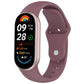 Mauve silicone reverse-buckle watch band shown attached to a fitness tracker