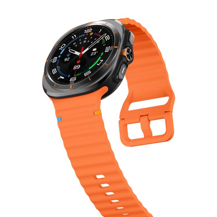 Orange silicone watch band with ridged texture and buckle, shown on a Galaxy Watch Ultra2