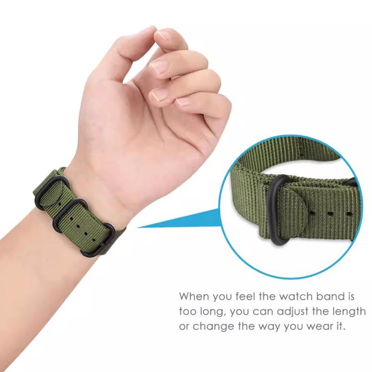 Army green nylon watch band worn on wrist, showing adjustable ring buckle closure