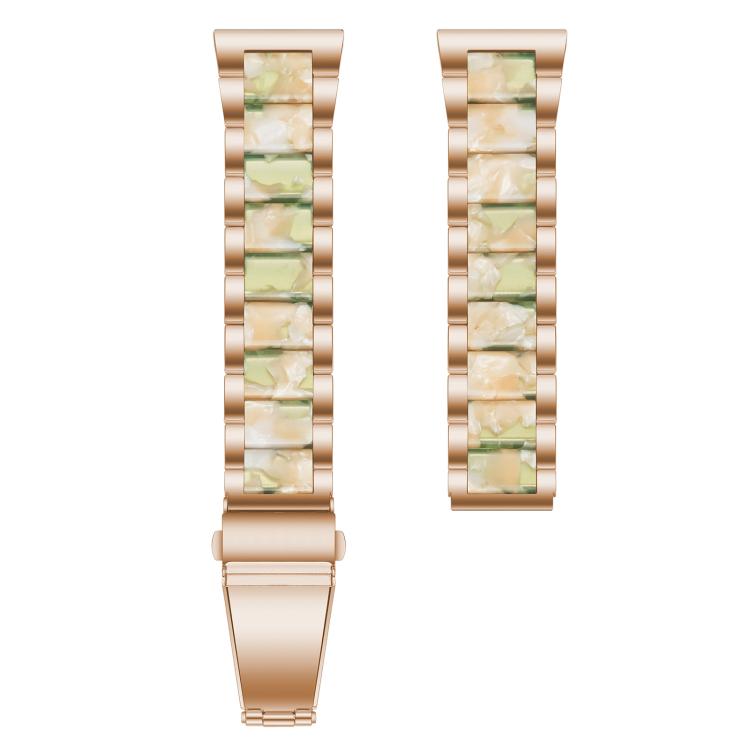 Close-up of rose gold band links with green and cream resin inlays