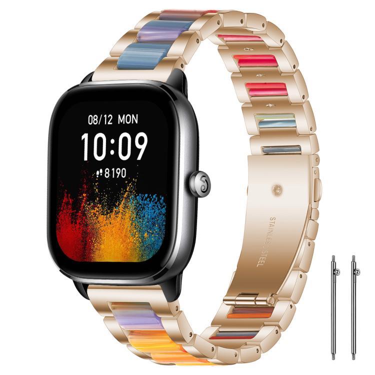 Rose gold metal watch band with multicolor resin links on a rectangular watch