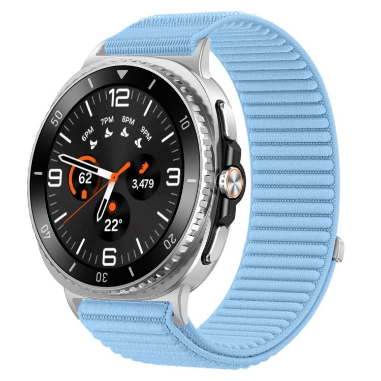 Light blue woven nylon hook-and-loop watch band fitted to a silver smartwatch