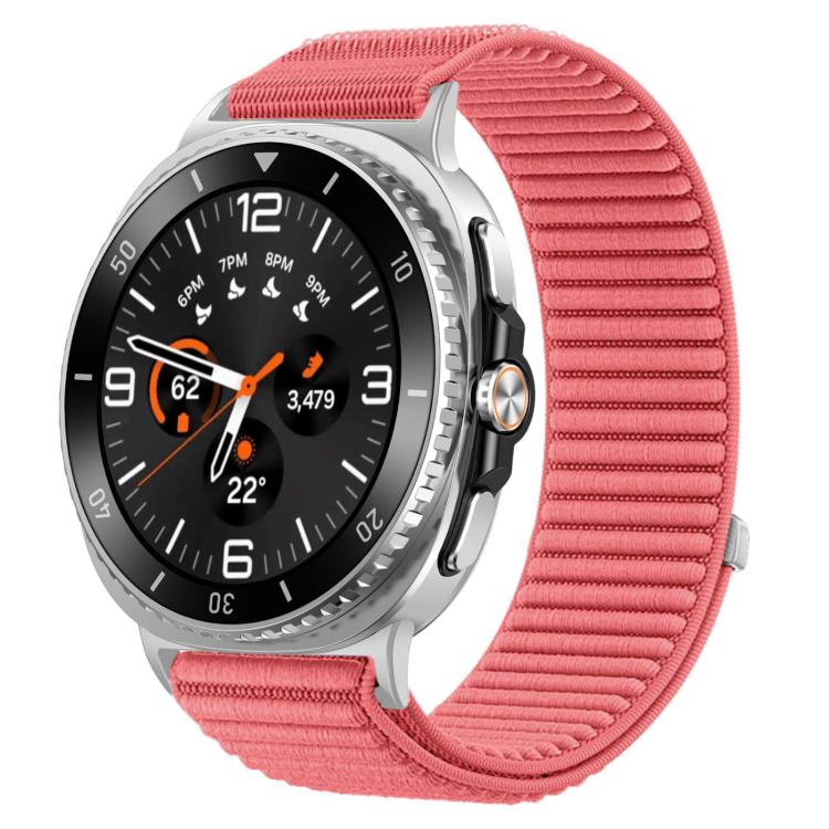 Pink woven nylon watch band with hook-and-loop closure, shown attached to a round smartwatch