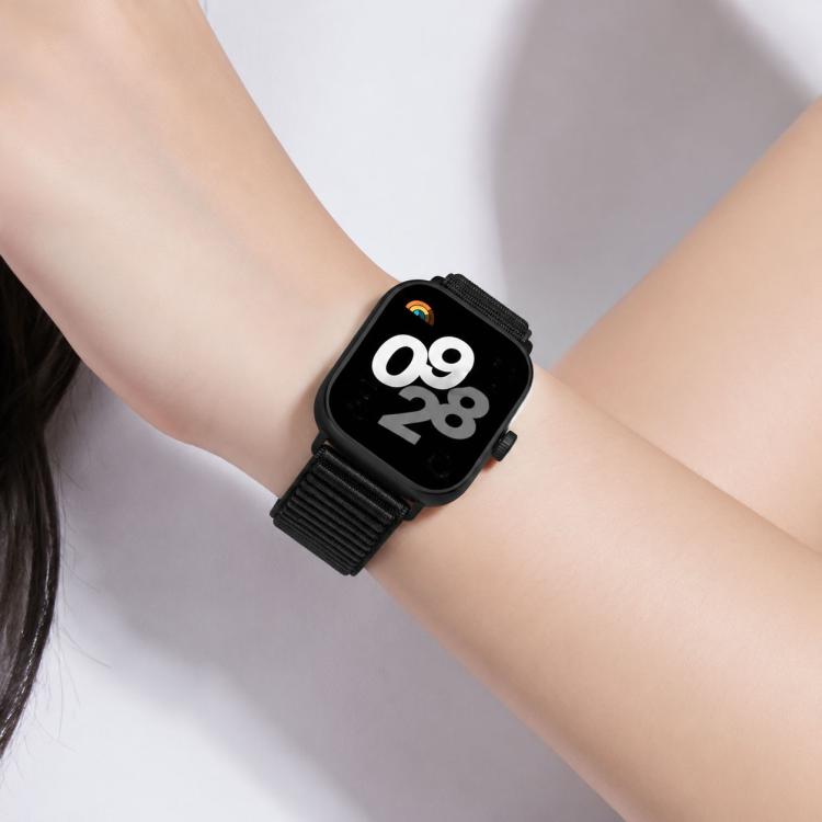 Black woven nylon watch band worn on a wrist