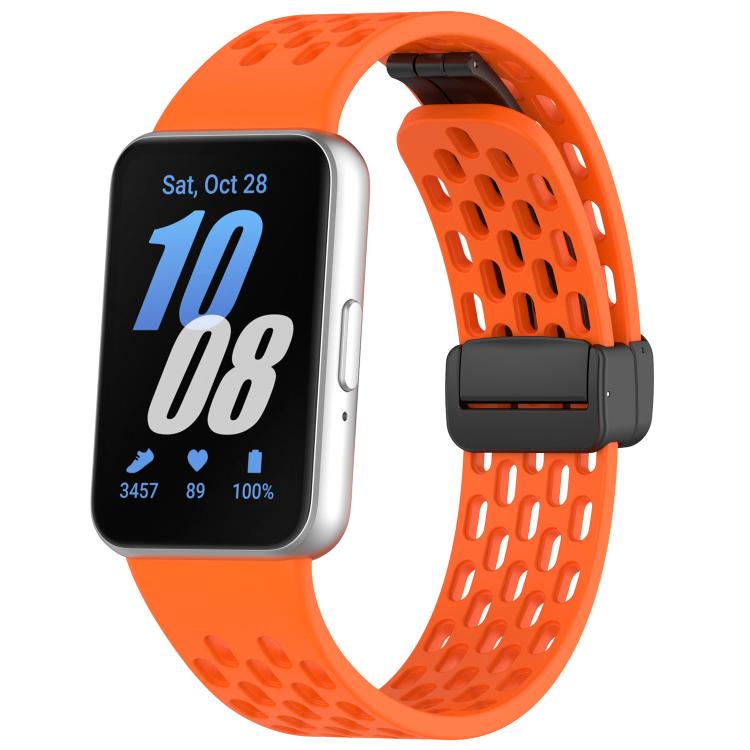 Orange perforated silicone watch band with black magnetic buckle on Galaxy Fit3