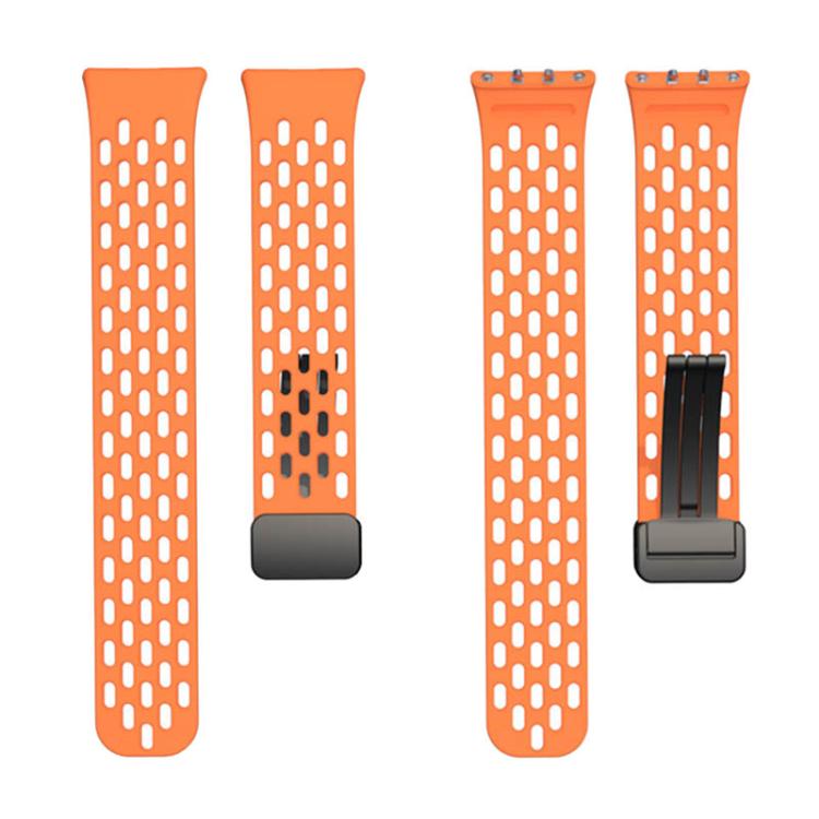 Orange perforated silicone watch band shown in two pieces with magnetic folding clasp