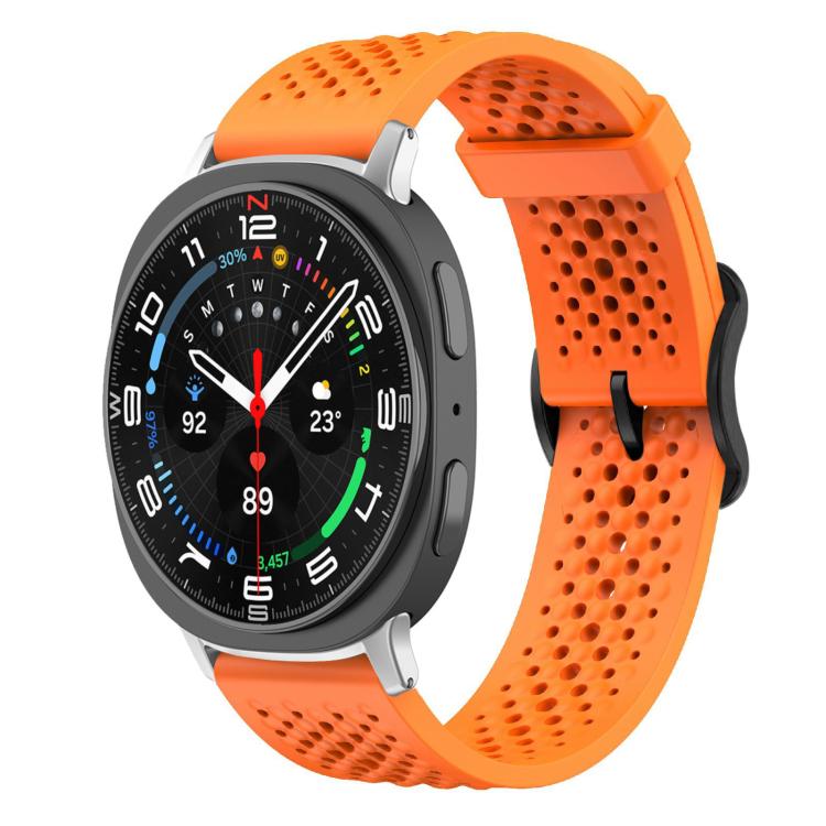 Orange perforated silicone watch band fitted to a round smartwatch