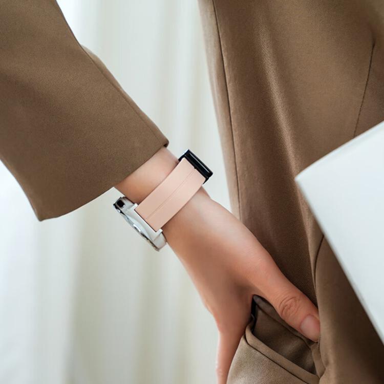 Peach silicone watch band worn on the wrist