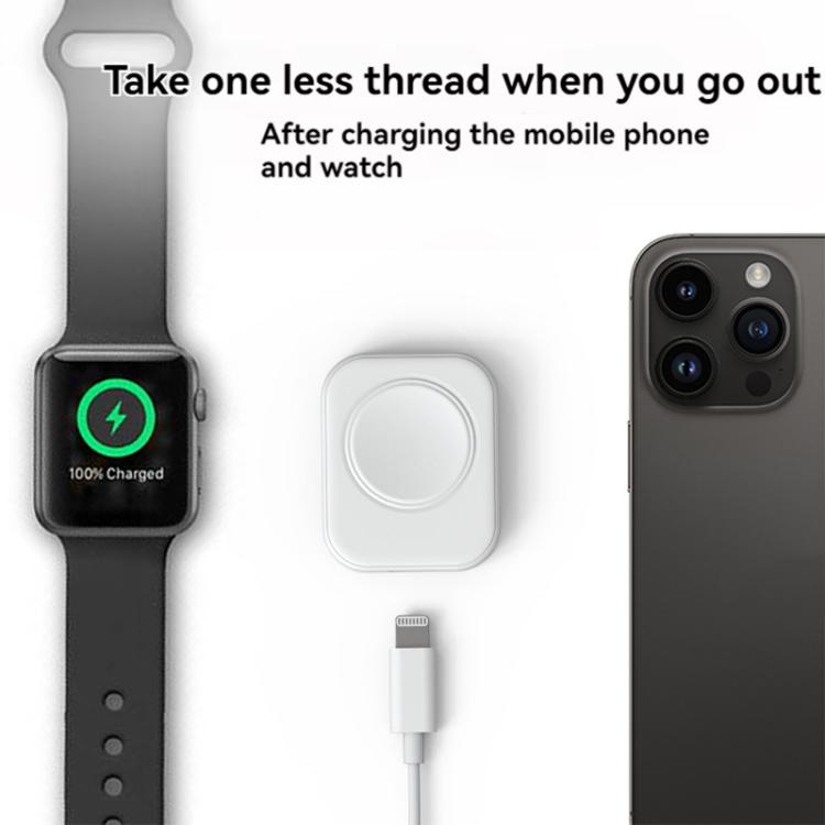White magnetic watch charger beside a smartwatch and phone, with a charging cable.