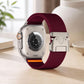 Wine red xDfind nylon watch band with parachute buckle, shown on the back of an Apple Watch