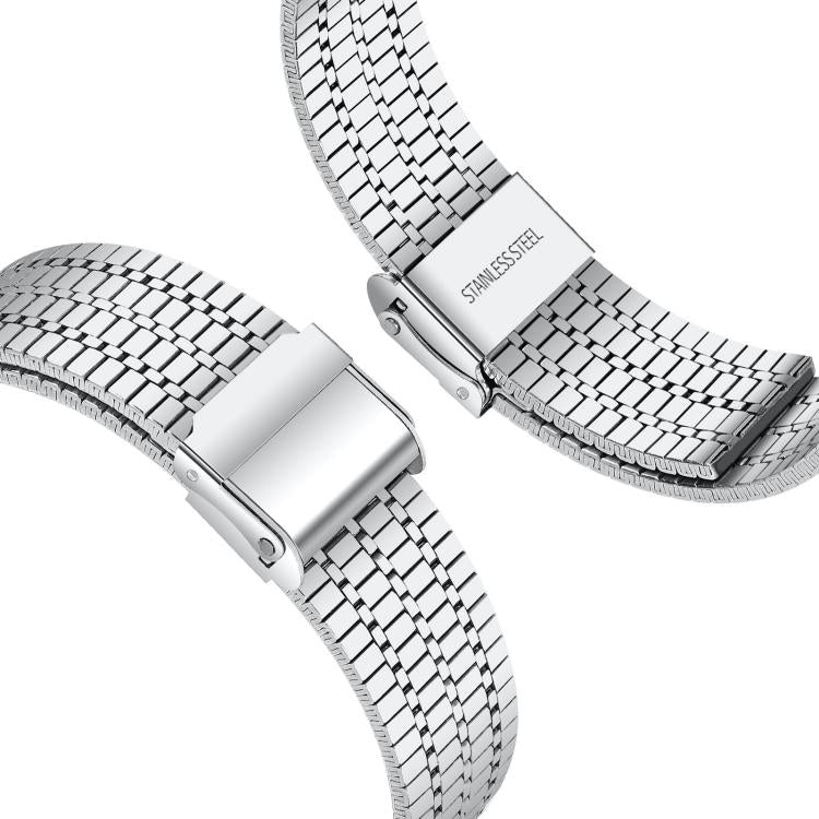 Silver stainless steel watch band with seven-row links and folding buckle, shown close up