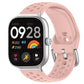 Pink perforated silicone sport watch band with silver buckle on a smartwatch