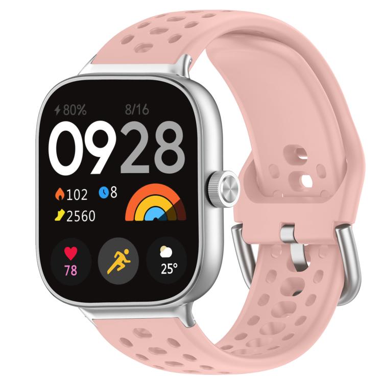 Pink perforated silicone sport watch band with silver buckle on a smartwatch