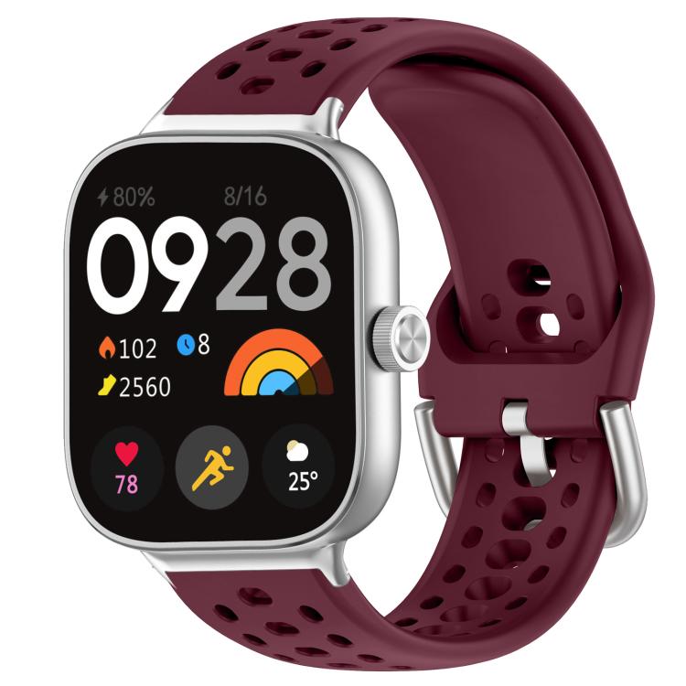 Wine red perforated silicone sport watch band with silver buckle on a smartwatch