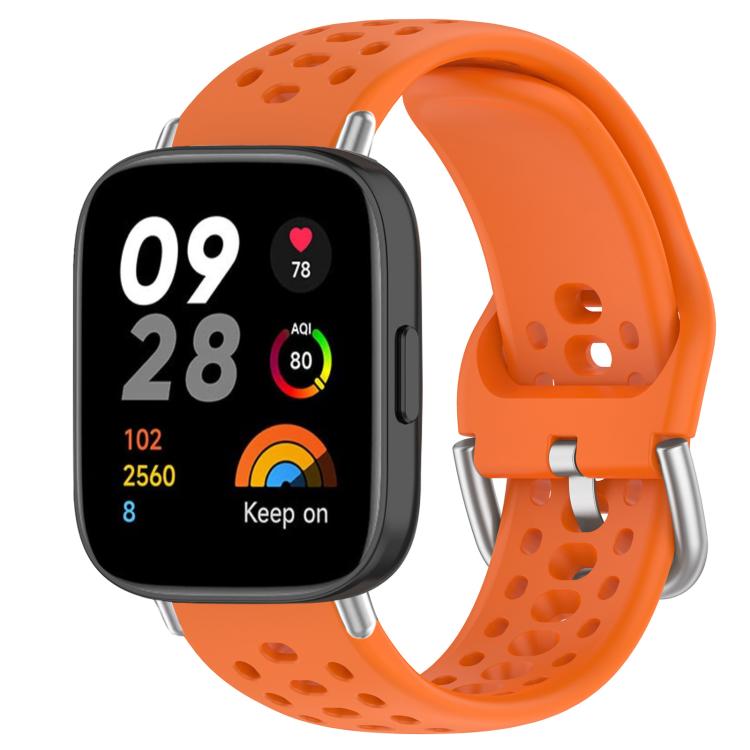 Orange perforated silicone sport watch band with silver buckle on a black smartwatch