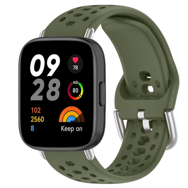 Olive green perforated silicone sport watch band with silver buckle on a black smartwatch