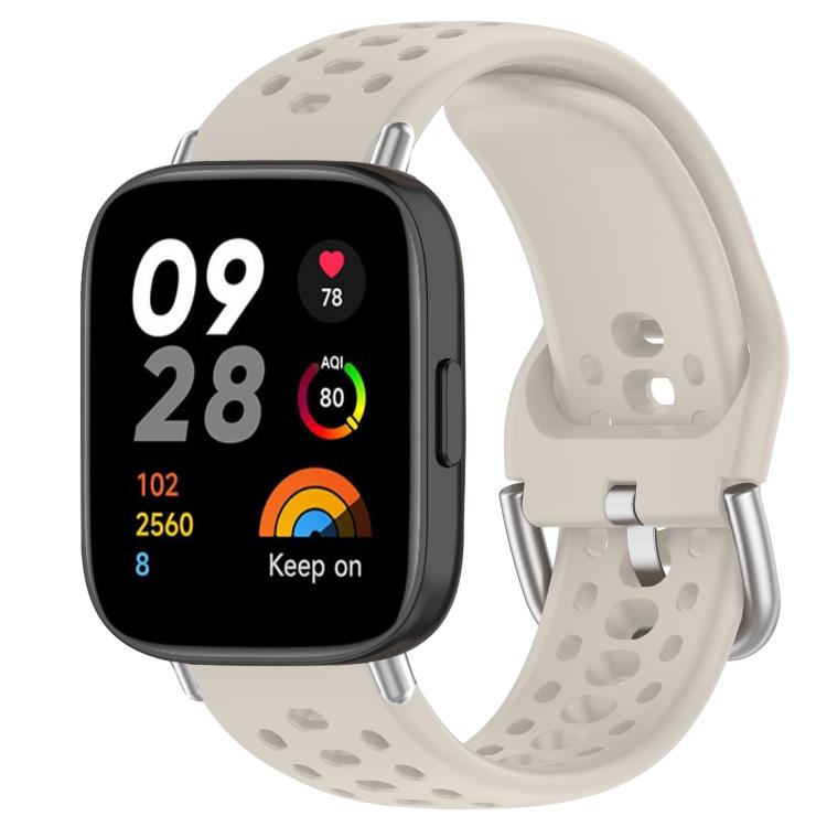 Off-white perforated silicone sport watch band with silver buckle on a black smartwatch