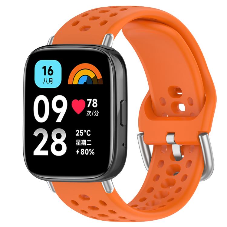 Orange perforated silicone sport watch band with silver buckle, shown on a smartwatch