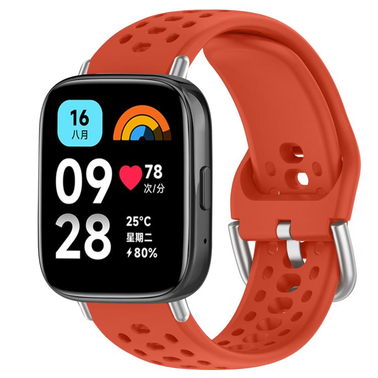 Red perforated silicone sport watch band with silver buckle, shown on a smartwatch