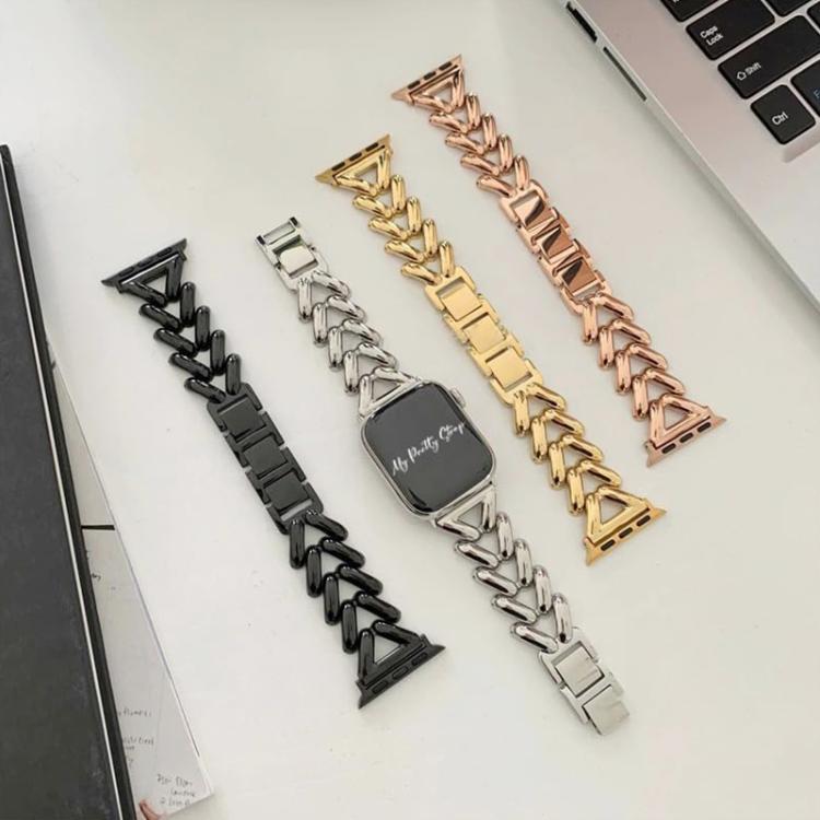 Four V-shaped metal Apple Watch bands in black, silver, gold, and rose gold.
