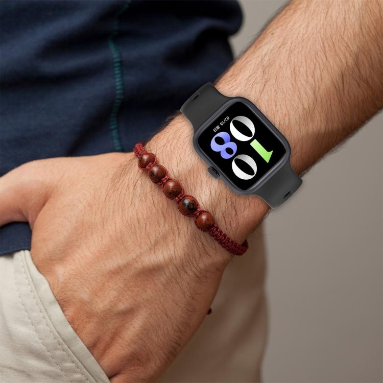 Dark gray silicone watch band worn on a wrist with a smartwatch