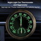 Round car thermometer/hygrometer gauge with glowing green dial numbers, black face, two pointers.