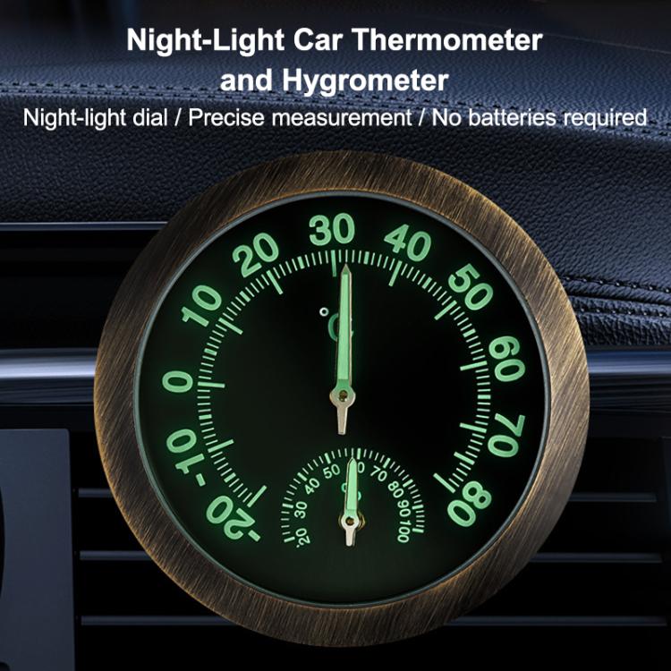 Round car thermometer/hygrometer gauge with glowing green dial numbers, black face, two pointers.