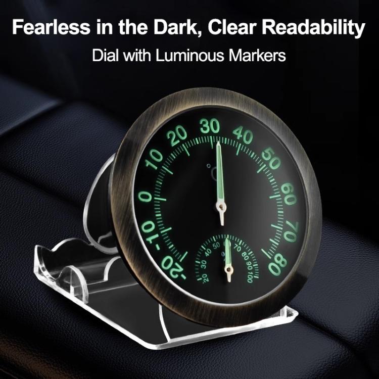Round car thermometer/hygrometer gauge with luminous green markers on black dial and two pointers.