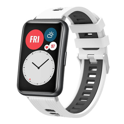 White and black silicone watch band with silver buckle, shown on a smartwatch