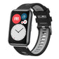 Black and gray silicone watch band with silver buckle, shown on a smartwatch