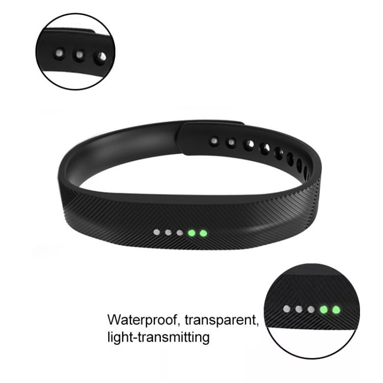 Black silicone Fitbit Flex 2 band showing adjustment holes and tracker lights through the strap