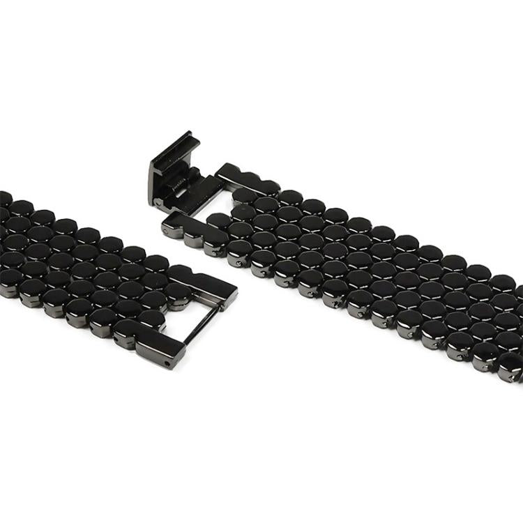 Close-up of black fish-scale metal watch band and folding clasp
