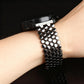 Black fish-scale metal watch band worn on a wrist