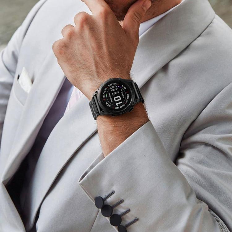 Black Garmin watch with a linked metal band worn on the wrist