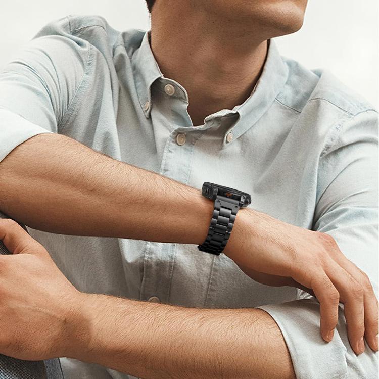 Black stainless steel watch band worn on a wrist