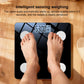 Smart body fat scale showing weight on screen with feet standing on glass