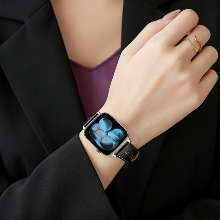 Black vegan leather watch band with white stitching, worn on a wrist