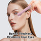 Pink hot compress eye massager positioned on the eye area for warming massage.