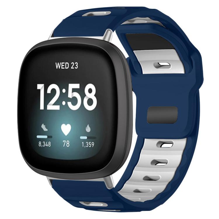 Fitbit silicone watch band in navy and white, shown fitted to a smartwatch