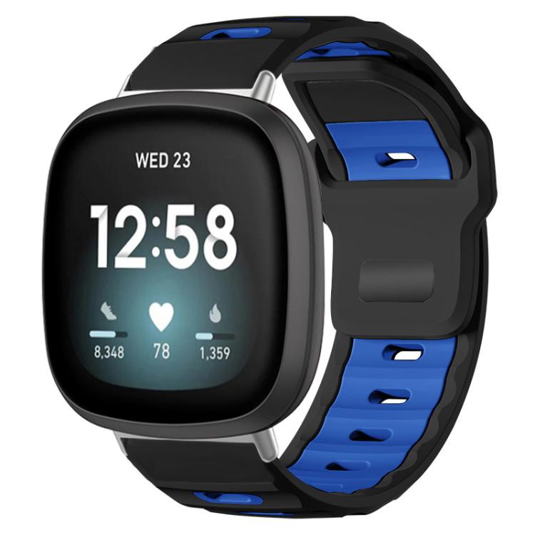 Fitbit silicone watch band in black and royal blue, shown fitted to a smartwatch