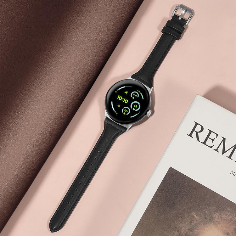 Black leather watch band fitted to a round silver smartwatch