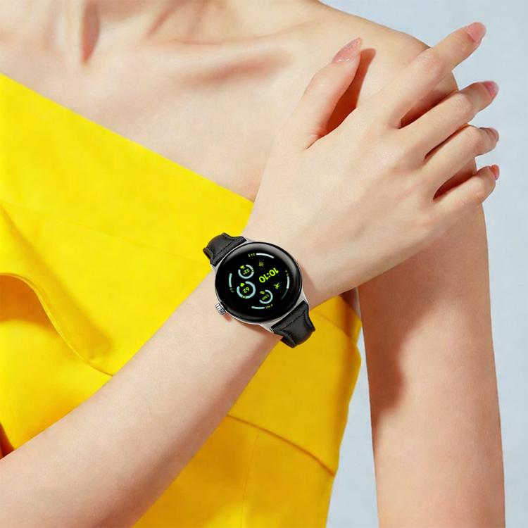 Black leather watch band worn on the wrist with a round smartwatch