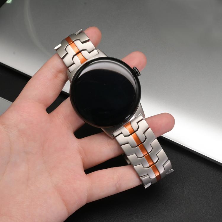 Silver titanium alloy watch band with orange accents attached to a smartwatch