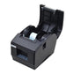 Black thermal label printer with open top cover showing label roll inside