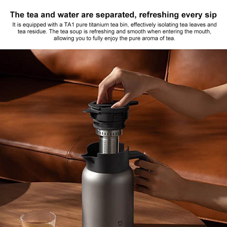 Titanium insulated kettle pouring tea, black lid and silver body