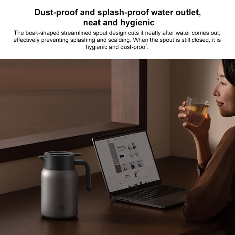 Titanium insulated kettle in silver with black lid on desk near laptop