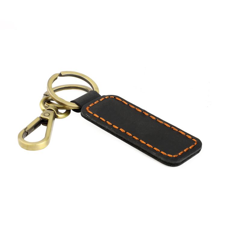 Black leather car key chain with orange contrast stitching and brass metal clasp