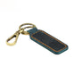 Dark teal leather car key chain with orange contrast stitching and brass metal clasp